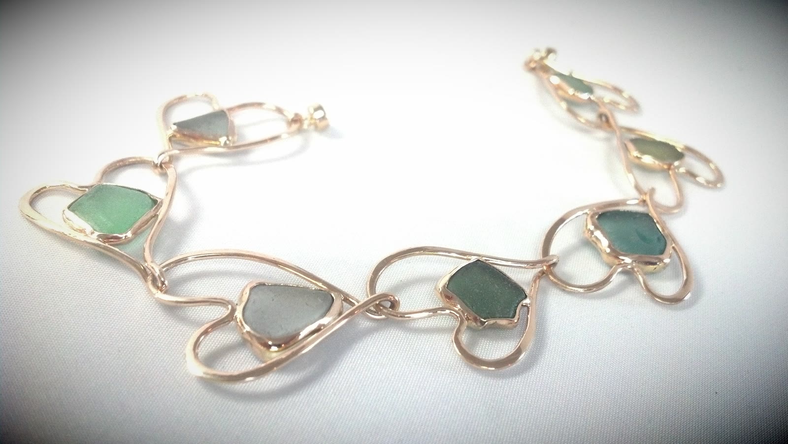 14kt bracelet of linked hearts to set customer sea glass. One of a kind gold bracelet